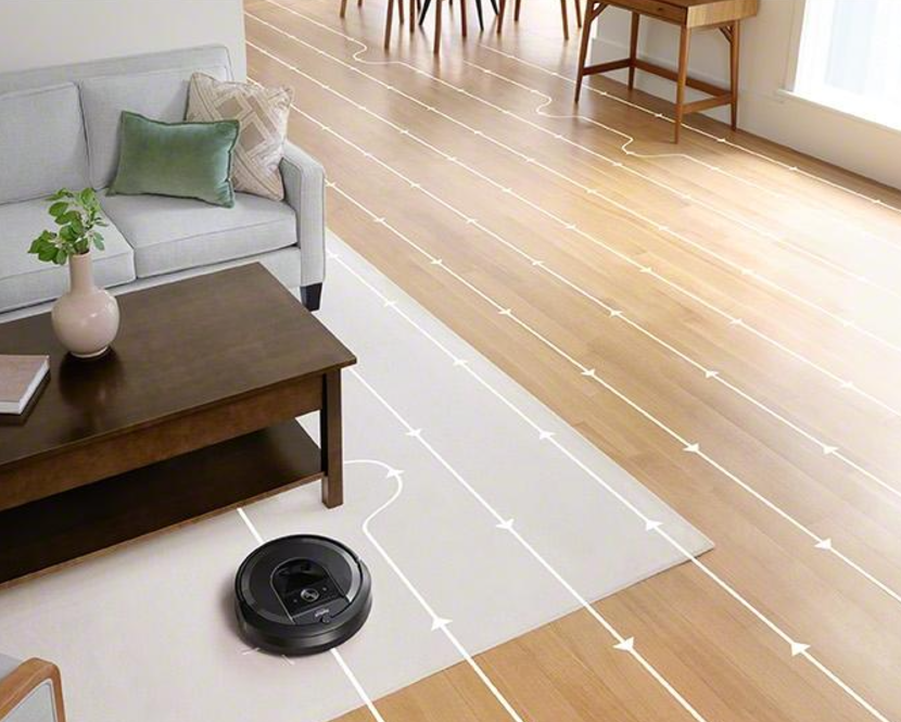 vacuum docking at its charging and cleaning station, emphasizing its self-cleaning feature.