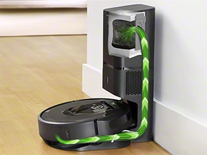A robotic vacuum docked at its charging and cleaning station, emphasizing its self-cleaning feature.